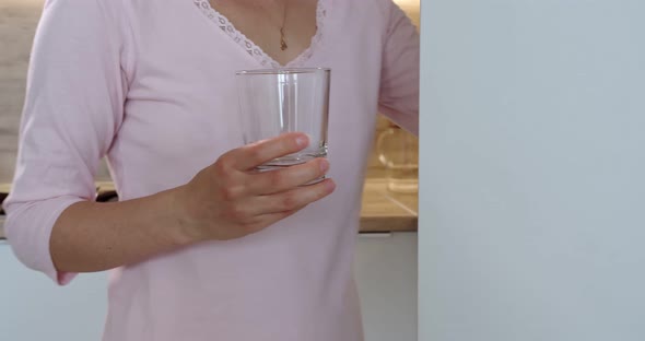 A Woman Pours a Drink for Breakfast