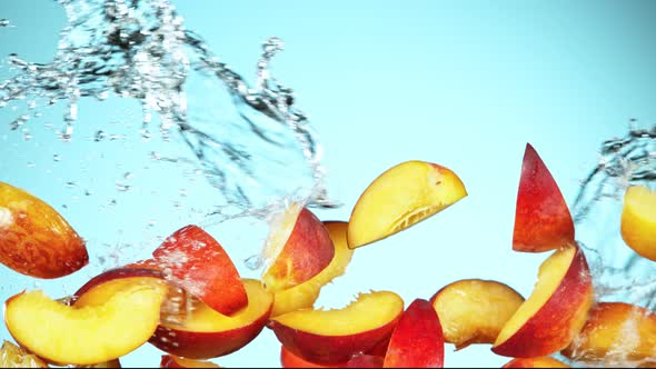 Super Slow Motion Shot of Flying Fresh Peach Slices and Water Side Splash at 1000Fps