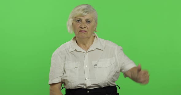 An Elderly Woman Showing No and Giving Her Thumb Down. Grandmother. Chroma Key