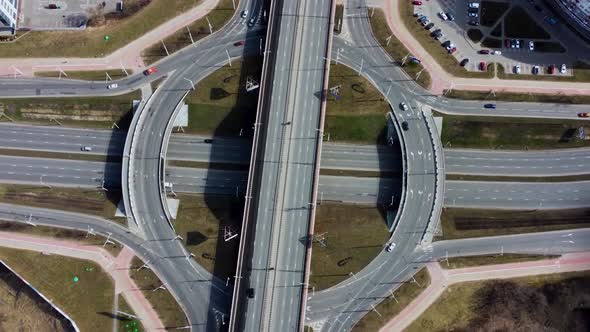 Aerial overhead top down view timelapse of car traffic on roundabout on a sunny day.