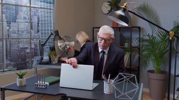 Elderly Mature Freelancer Man Walking and Sit at Office Workplace with Laptop Computer Start Working