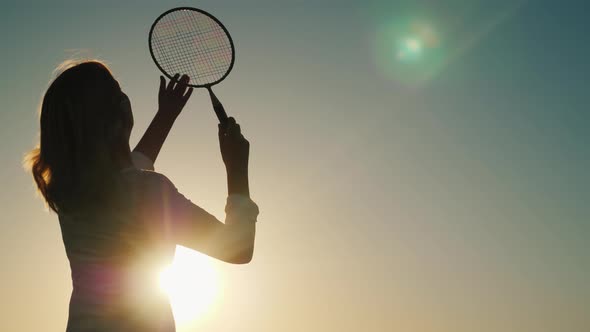 A Woman Strikes a Racquet on a Ruffle