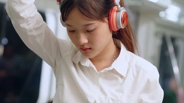 Young Woman Using Mobile Phone on Public Train