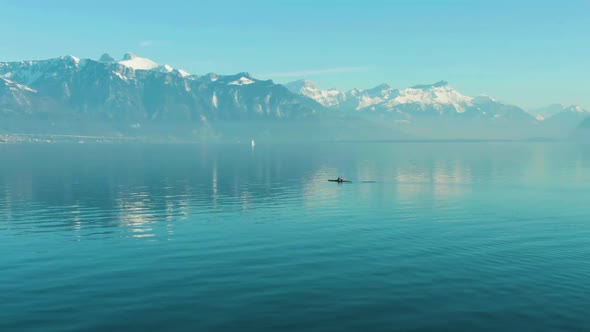 Two Men Kayaking on Clear Day on Blue Lake Geneva. Swiss Alps, Switzerland