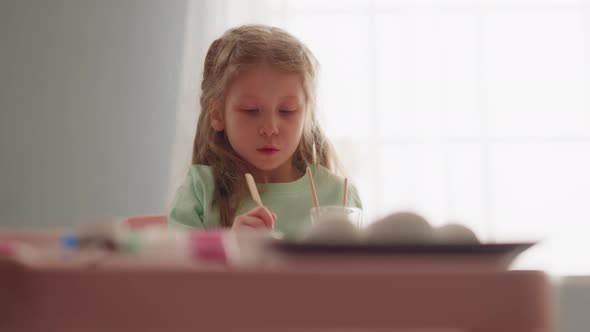 Blonde Girl Draws Marbling Pattern on Water in Art Studio