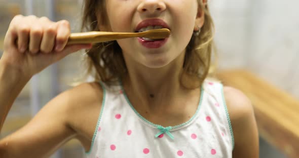 Little Girl Brushing Teeth in the Bathroom at Home