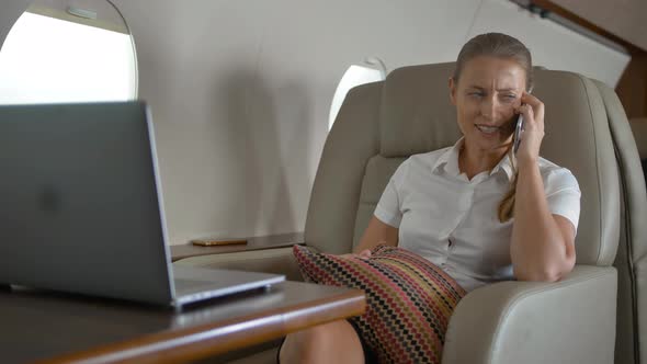 Happy Lady Speaking About Luxury Journey Inside of Private Jet