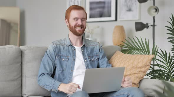 Creative Beard Man Celebrating Success, Working on Laptop