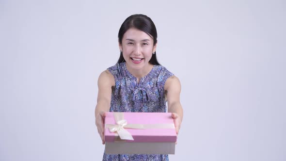 Happy Pregnant Asian Woman Giving Gift Box