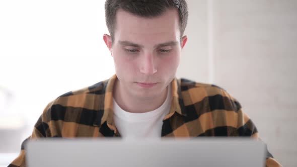 Close Up of Ill Young Man Coughing at Work