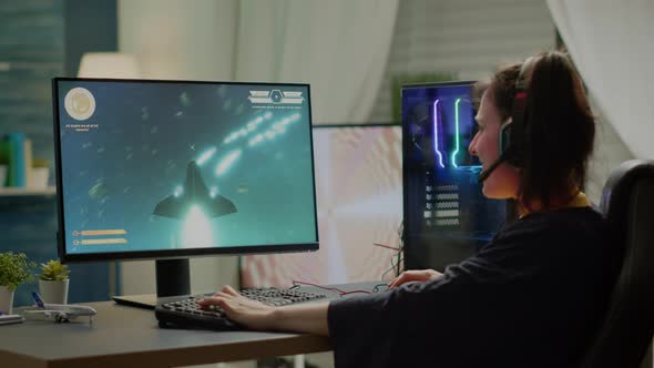 Player Sitting on Gaming Chair Playing Online Space Shooter Video Games