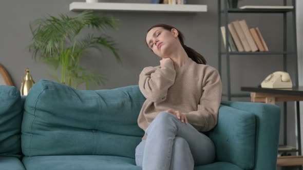 Woman Having Neck Pain While Sitting on Sofa