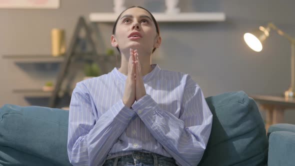 Portrait of Hispanic Woman Praying with Hands Crossed