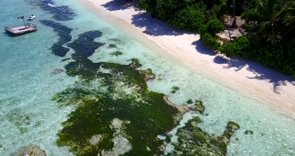 Natural birds eye copy space shot of a sandy white paradise beach and aqua turquoise water background