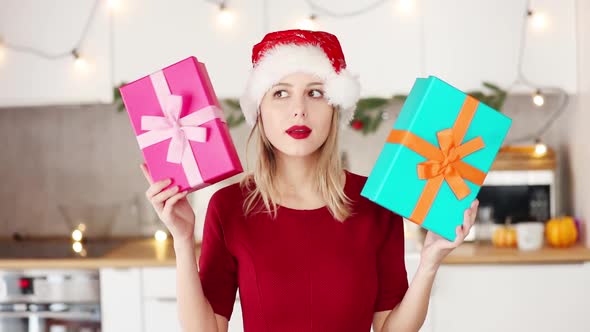 girl in hat and red dress with a Christmas gift boxes