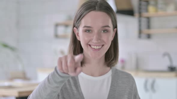 Portrait of Young Woman Pointing Finger at Camera