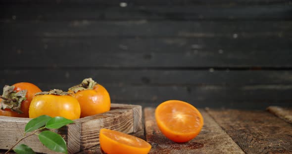 Halves Fresh Persimmon Roll on the Table. 