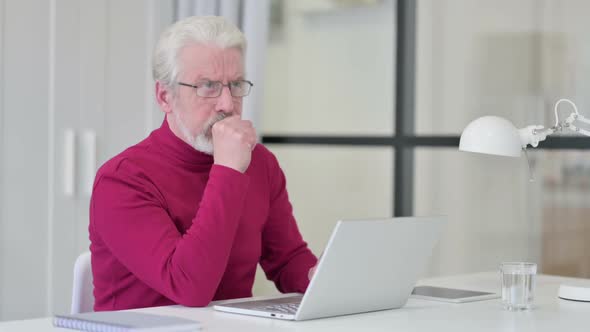 Old Man Having Coughing While Working on Laptop