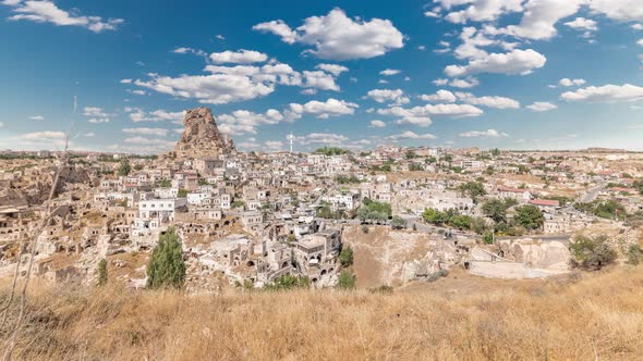 View of Ortahisar Town Old Houses in Rock Formations From Ortahisar Castle Aerial Timelapse.