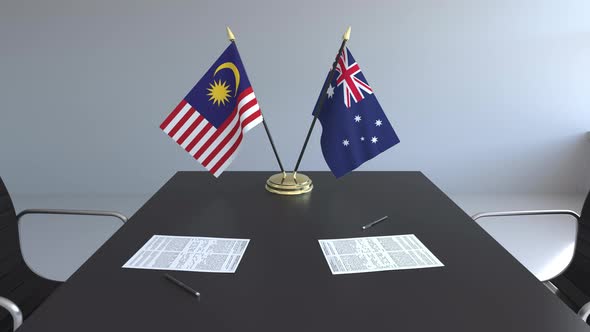 Flags of Malaysia and Australia on the Table