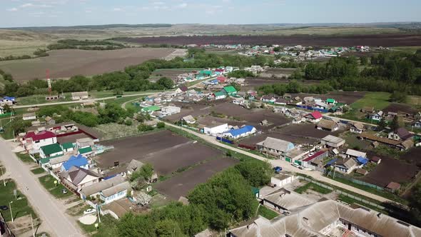 Aerial View on Russian Village and Surrounding Countryside Meadows and Fields 