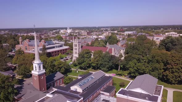 Forward aerial of buildings and trees at campus of Hope College, MI