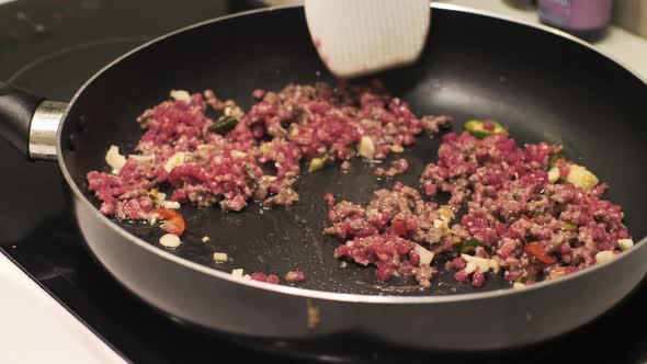 Close Up of Ground Beef Being Cook in a Non Sticky Fry Pan on an Electric Stove