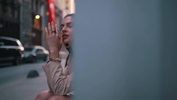 Girl Sitting on an Empty City Street