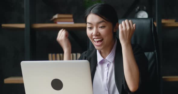 Overjoyed Asian Young Business Woman Working at Laptop Computer at Office