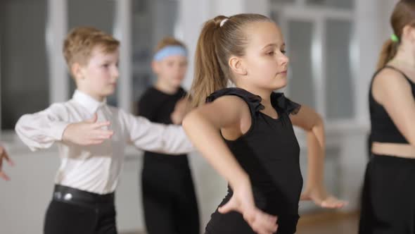 Portrait of Beautiful Little Girl Dancing with Classmates in Dancing School in Slow Motion