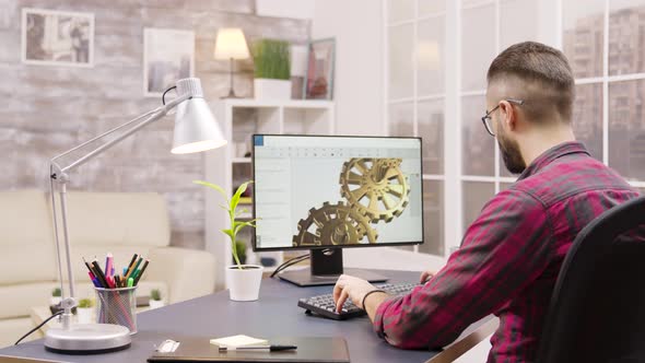 Back View of Male Engineer Working on a Mechanical Concept