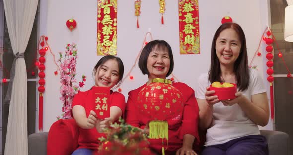 Happy Asian Multi Generations Family Celebrating Chinese New Year. Showing Lucky Red Envelope.