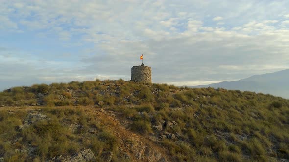 Old Abandoned Lookout Tower with a Spanish Flag