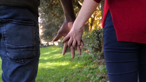 Mixed-Race Couple Holding Hands.Interracial love symbol-slow motion