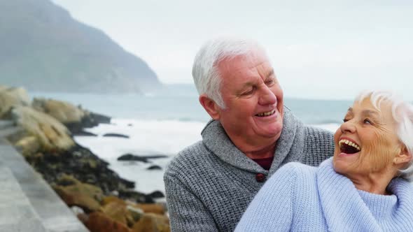 Senior couple embracing each other on the beach