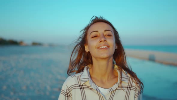 Outdoors Portrait of Happy Attractive Mixed Race Woman Enjoying Sunset on Wild Sea Sand Beach with