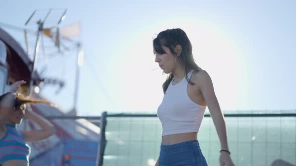 Close View of Girl Spinning Around on Roller Skates in Bright Sunshine