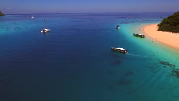 Aerial view of traditional long-tail boats in the bay of Chao Mai National Park in Thailand.