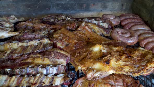 Tasty Argentinian barbecue called asado being grilled in traditional parrilla