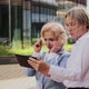 Female Coworkers Discussing Over Tablet While Standing Outside Office Building - VideoHive Item for Sale