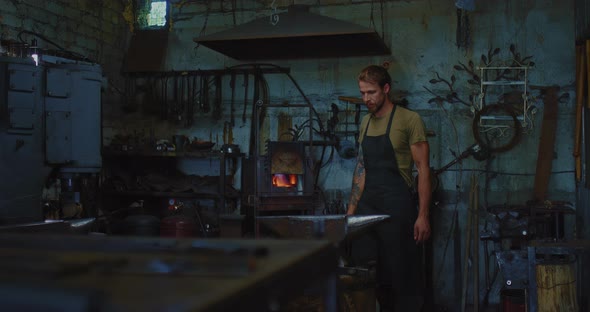 Cool Guy is Working in Forge Handsome Slavic or Scandinavian Man is Blacksmith  Prores