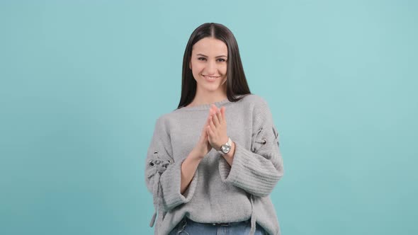 Applauding Young Pretty Girl, Clapping on Turquoise Background.