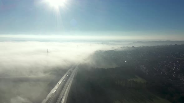 Aerial view of fog in the countryside covering a motorway