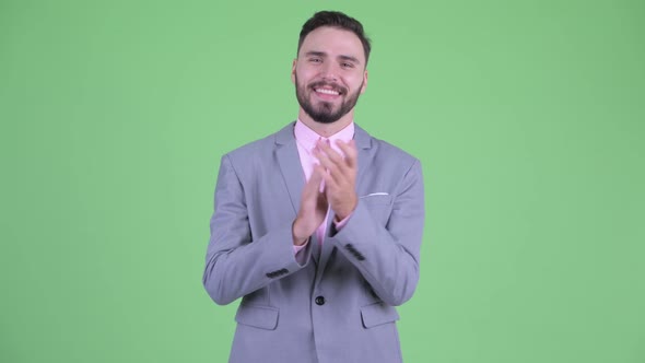Happy Young Bearded Businessman Clapping Hands