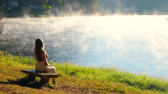 Woman Relax on Morning Lake with Mist