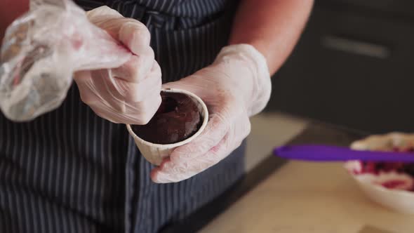 Pouring in the Cupcake Cherry Sauce