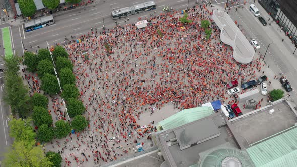 Cinematic Top Down Aerial of a Huge Crowd of protesters occupying a downtown city. The Cancel Canada