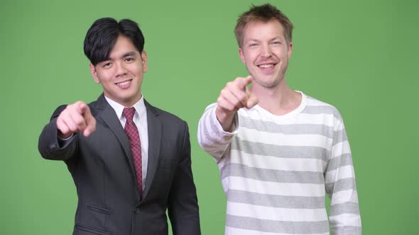 Young Handsome Asian Businessman and Young Scandinavian Businessman Working Together