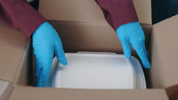 Volunteers in Gloves Preparing Donation Boxes at Warehouse