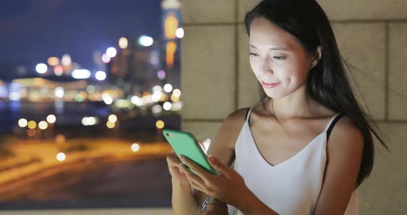 Woman use of mobile phone at night 